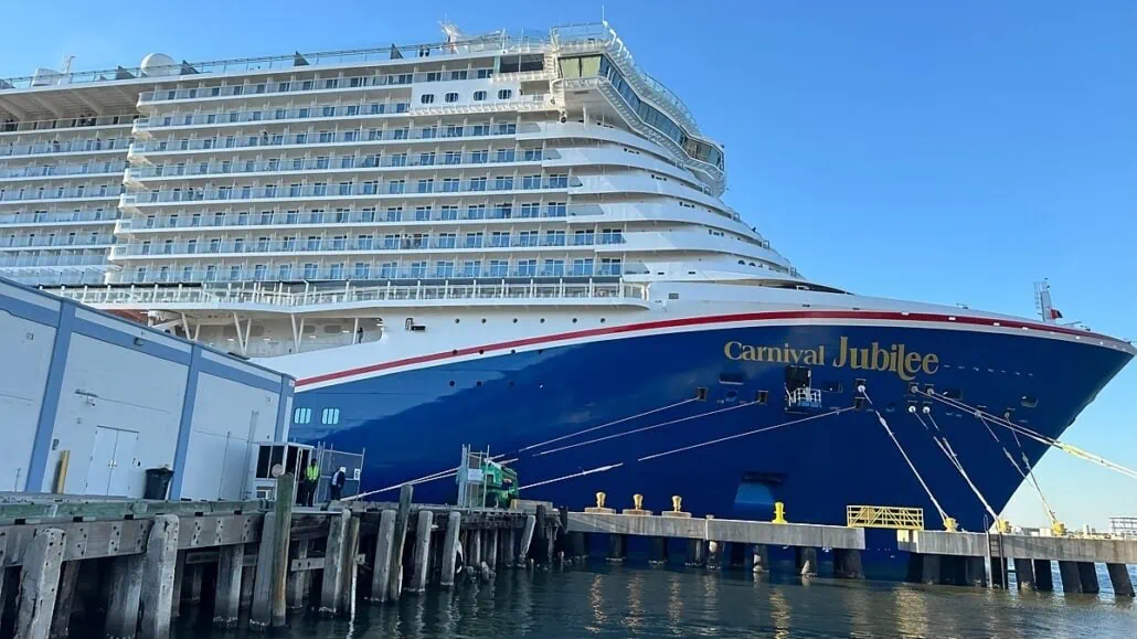 A large cruise ship, the Carnival Jubilee, docked at a VIP dock.