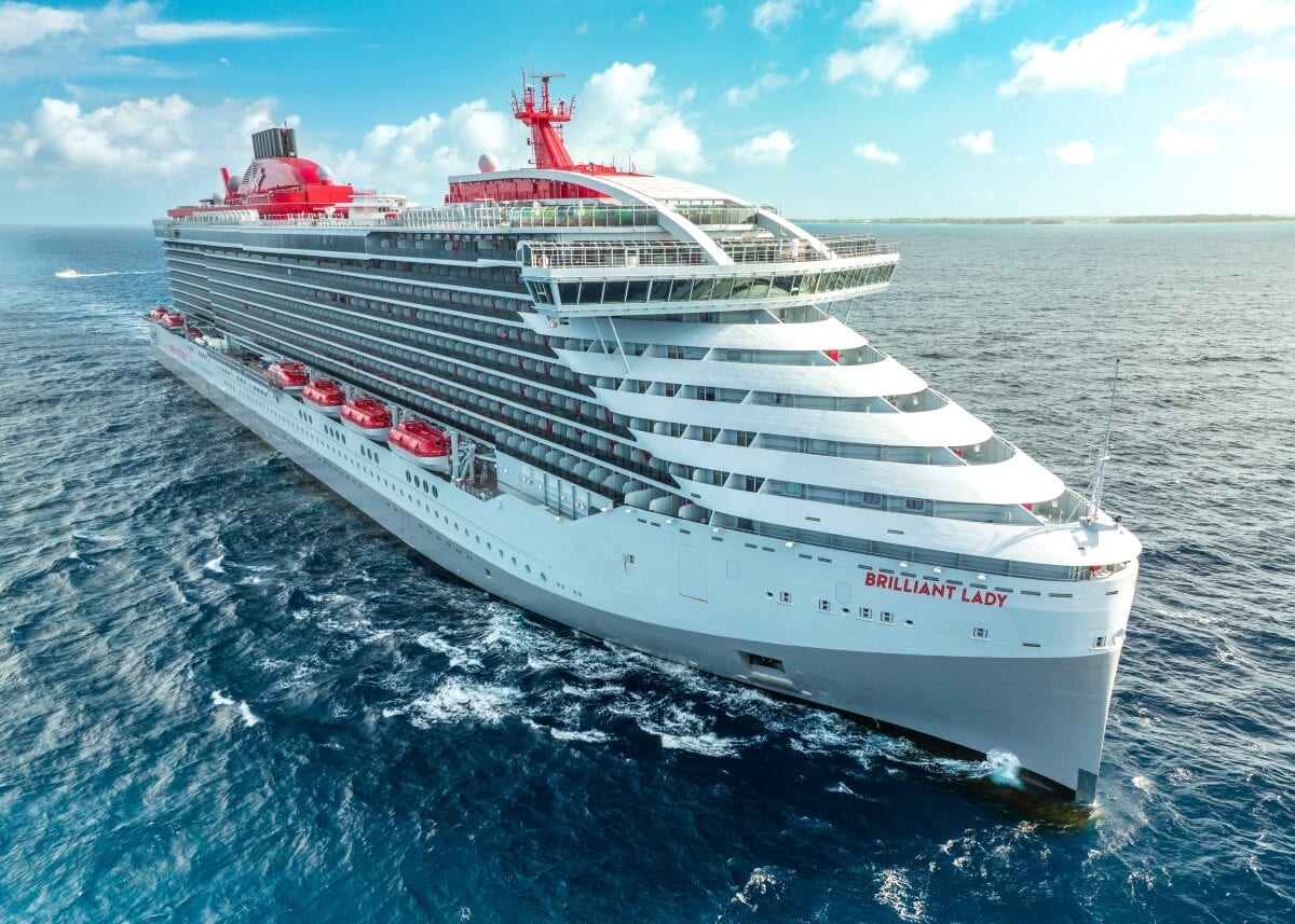 Aerial view of the Virgin Ship "Brilliant Lady" sailing in a blue ocean under a clear sky.