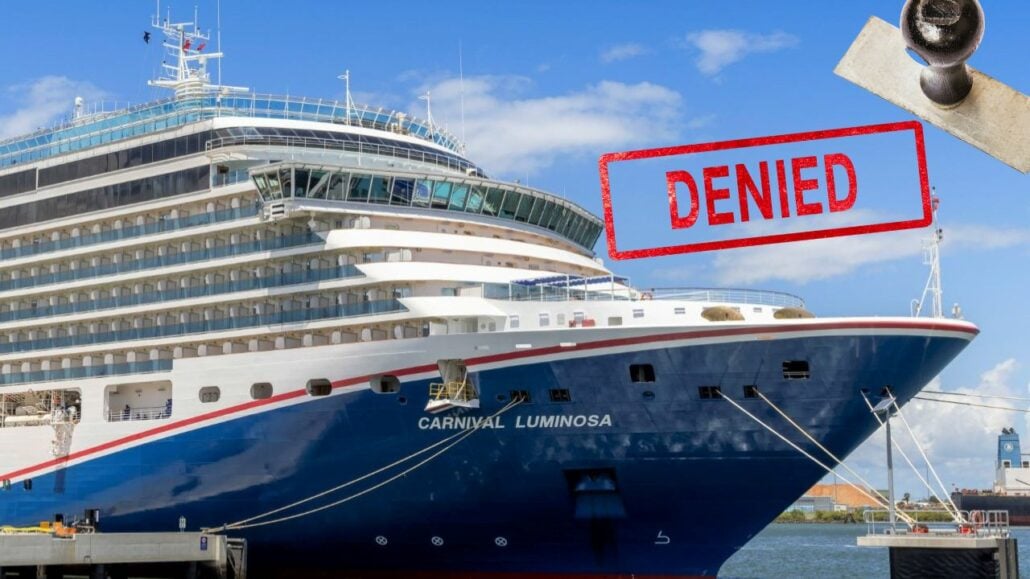 A cruise ship docked at a dock with a sign that says denied boarding.