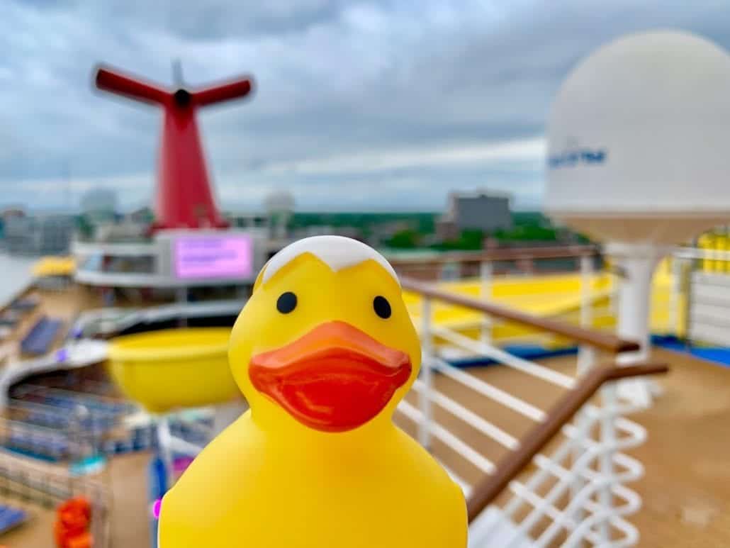 A rubber duck sits on the deck of a cruise ship.