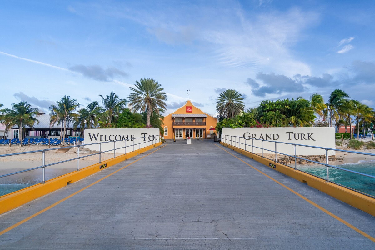 A walkway with white signs on either side reading 