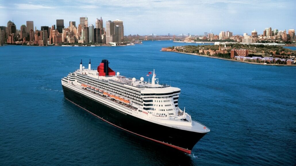 Queen Elizabeth cruise ship sailing in the water with a city in the background, offering a pet-friendly voyage for travelers desiring cruise lines that allow pets.