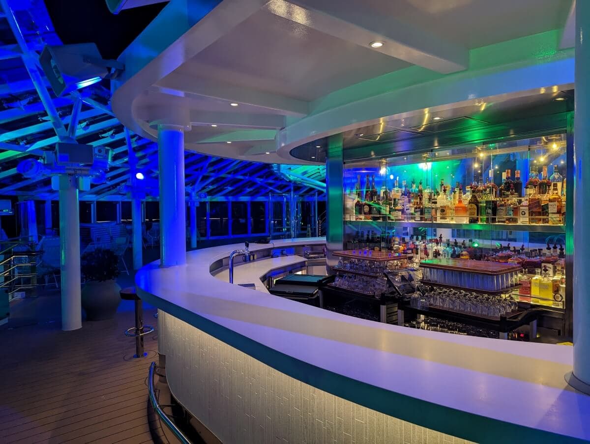 Illuminated outdoor bar on a cruise ship at night.